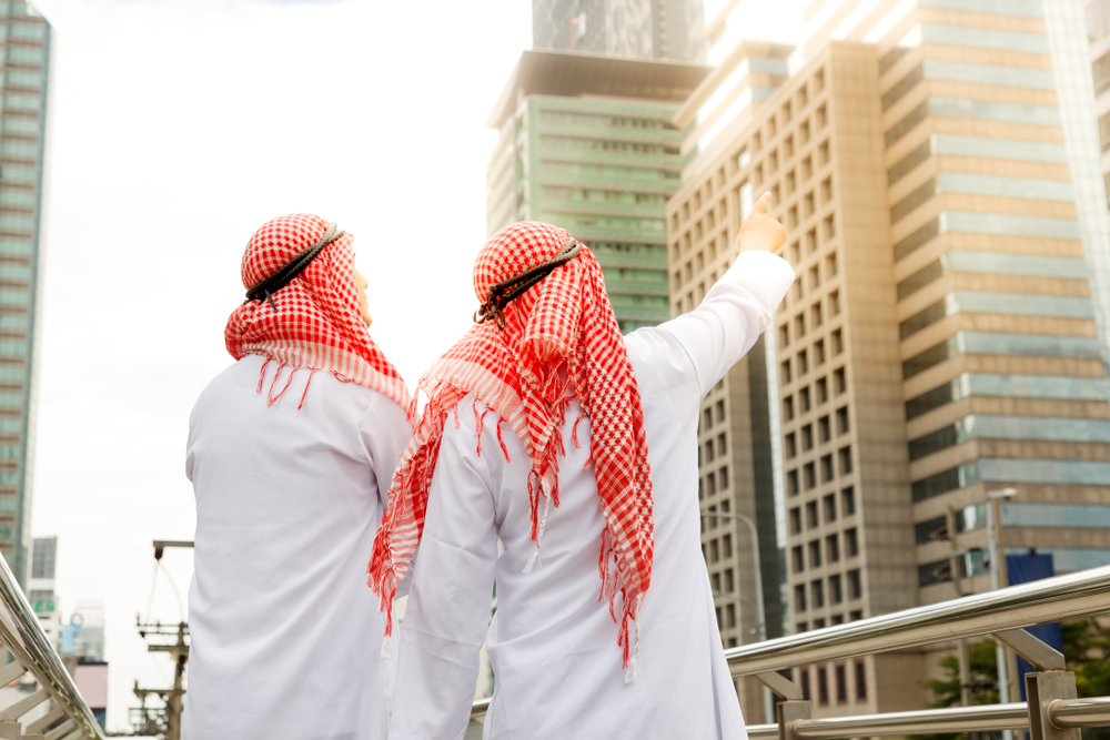 Two Kuwaiti men standing in Kuwait's streets.