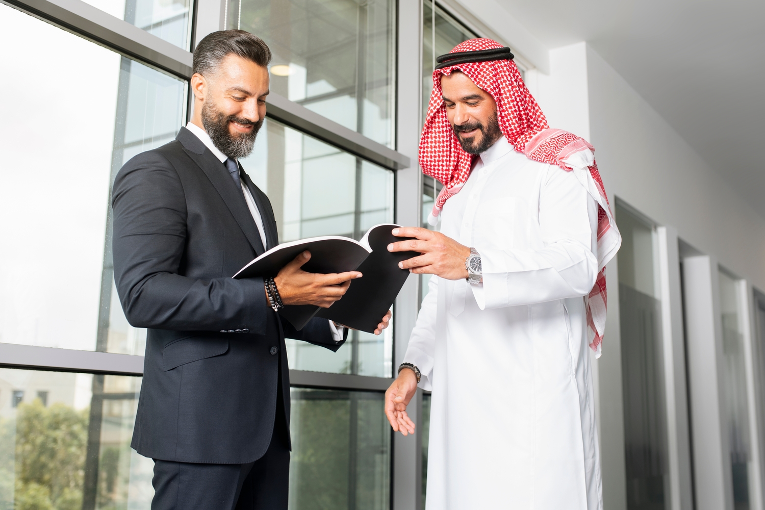 رجلان يناقشان العمل وهما يبتسمان.