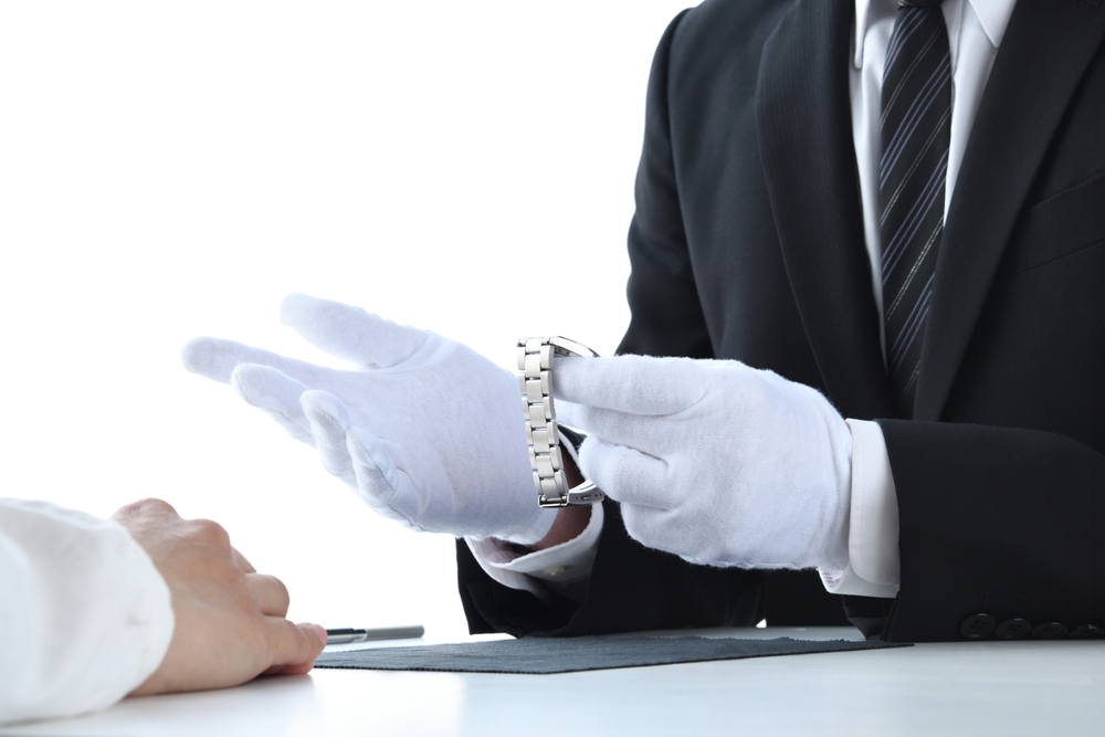 Appraiser checking the condition of a watch.